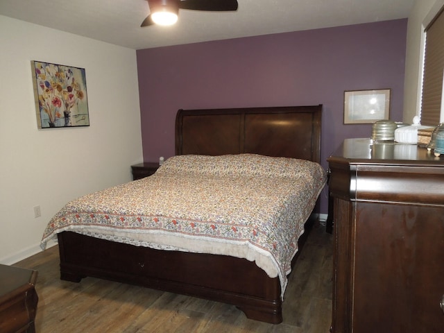 bedroom with dark wood-style floors, ceiling fan, and baseboards