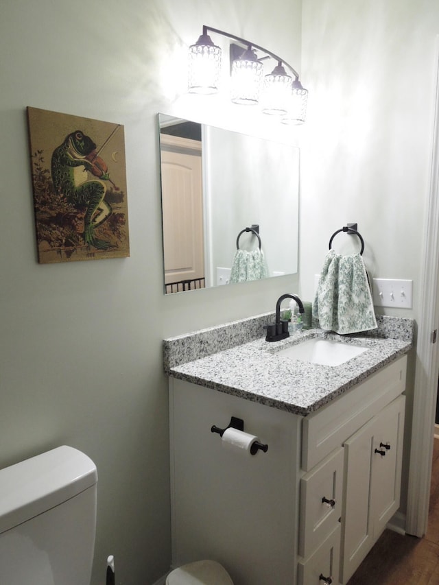 bathroom featuring toilet and vanity