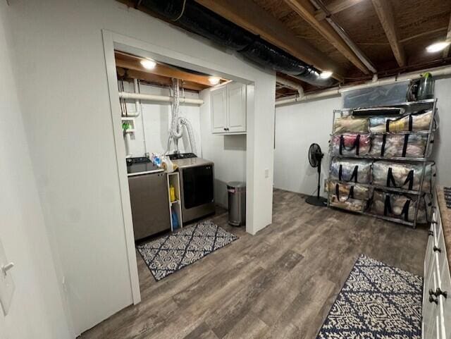 laundry area with dark wood-style floors and cabinet space