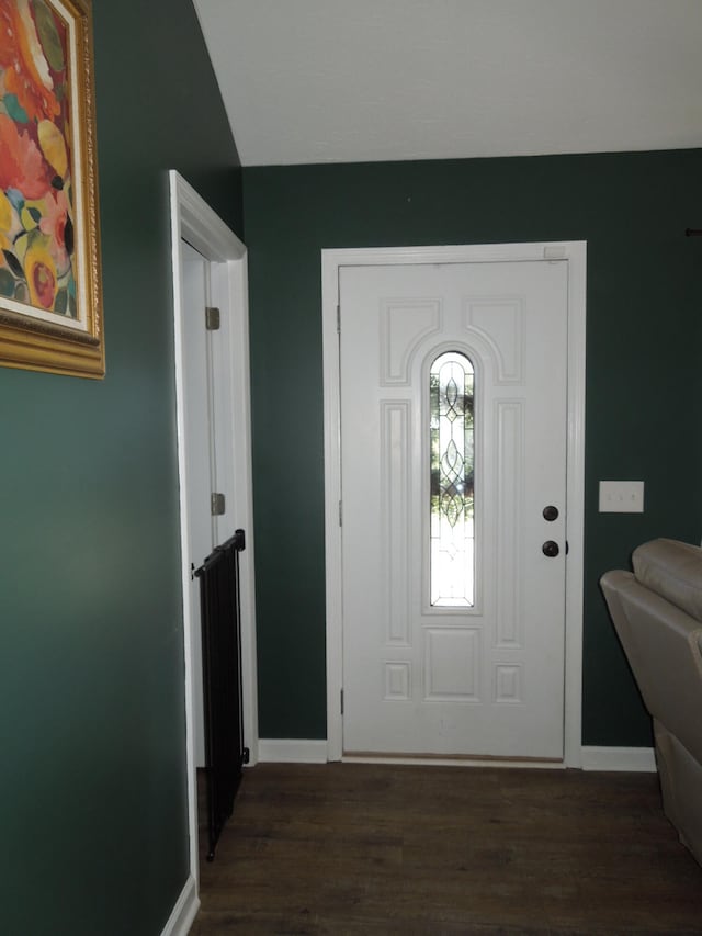 foyer with baseboards and dark wood-style flooring