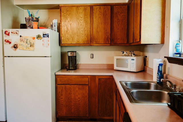 kitchen with white appliances and sink