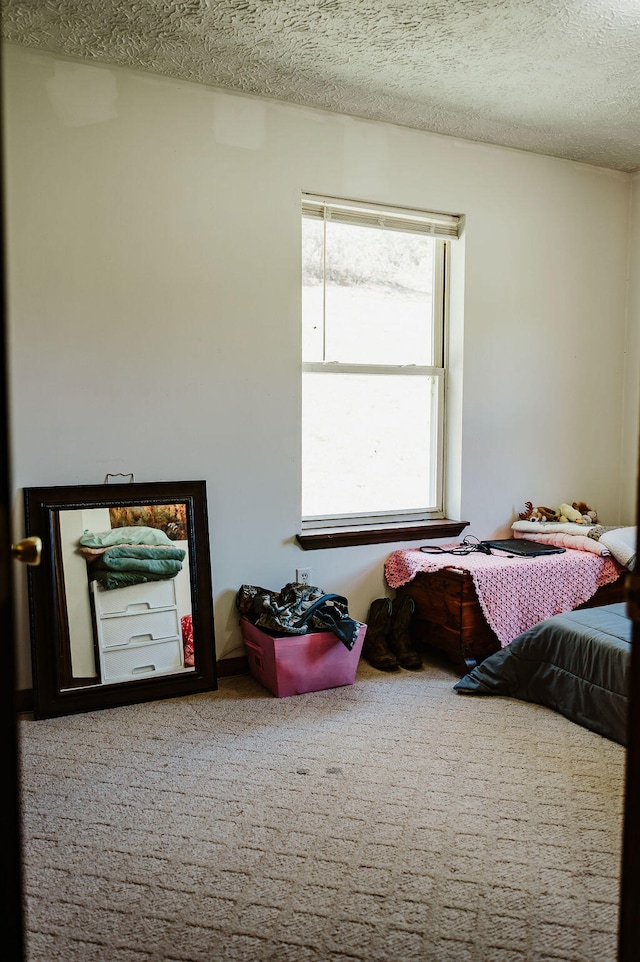 carpeted bedroom featuring a textured ceiling