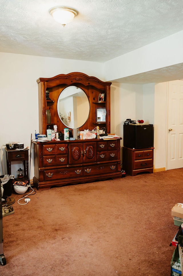 carpeted bedroom with a textured ceiling