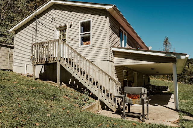 view of side of home with a yard and a patio