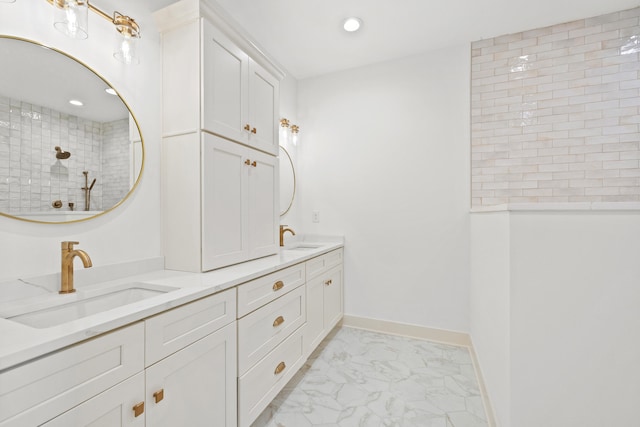 bathroom with a tile shower and vanity