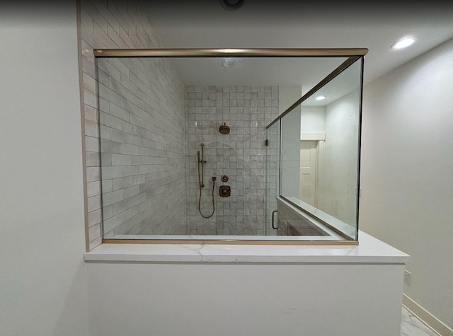 bathroom with a shower with door