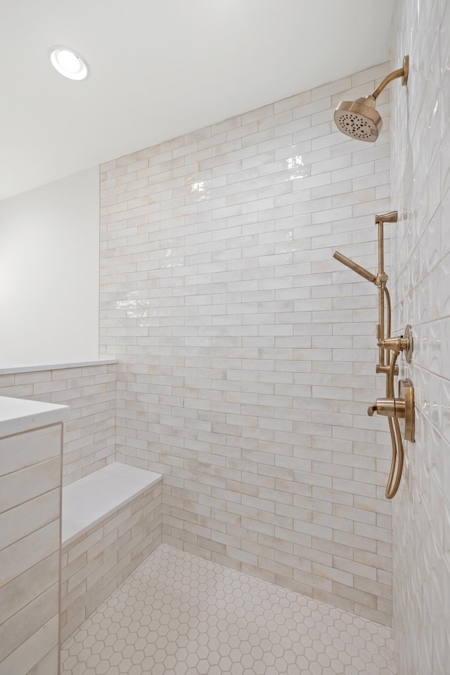 bathroom with tile patterned floors, tile walls, and tiled shower