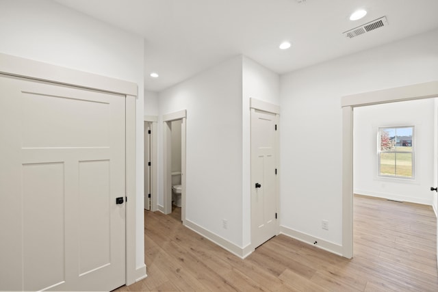 corridor with light wood-type flooring