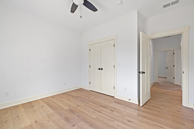 unfurnished bedroom featuring a closet, ceiling fan, and light wood-type flooring