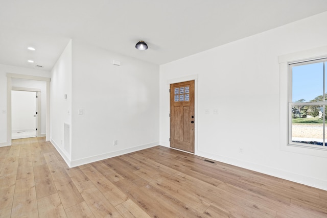 unfurnished room with light wood-type flooring