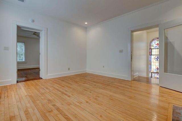 spare room featuring light hardwood / wood-style floors, plenty of natural light, and ornamental molding