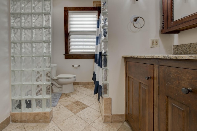 bathroom featuring a shower, vanity, and toilet