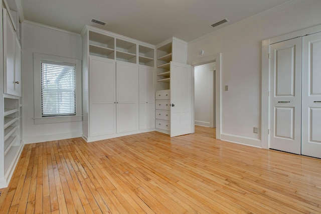 unfurnished bedroom featuring ornamental molding and light wood-type flooring