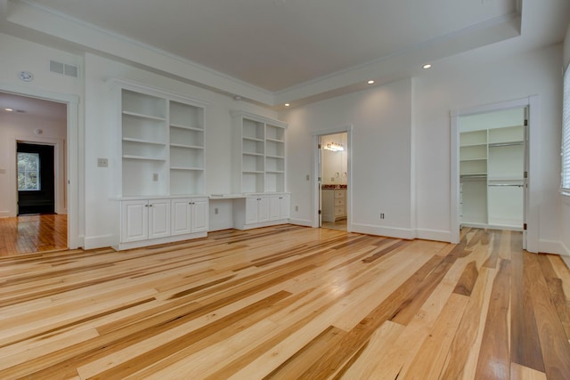 unfurnished living room with light wood-type flooring and crown molding