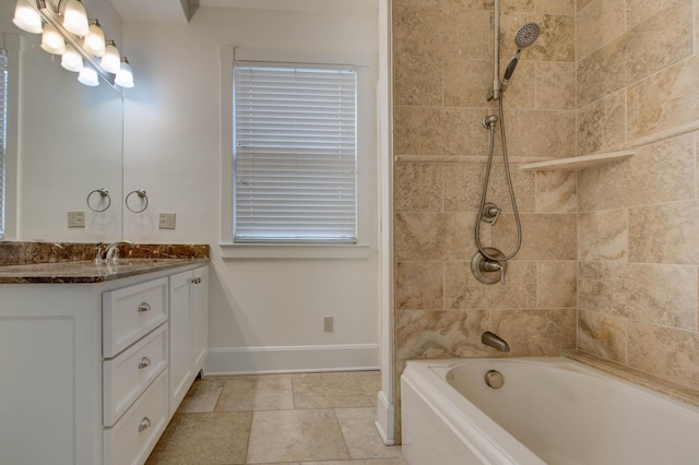 bathroom featuring vanity and tiled shower / bath