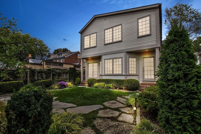 rear view of property featuring a yard