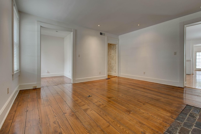 unfurnished room with hardwood / wood-style floors