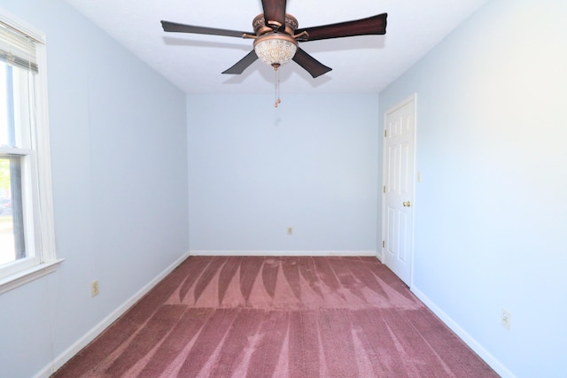 spare room featuring baseboards, carpet flooring, and a ceiling fan