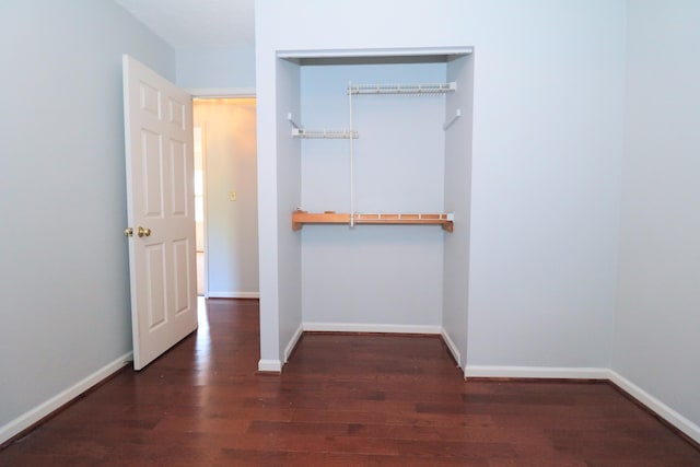 interior space featuring baseboards, a closet, and wood finished floors