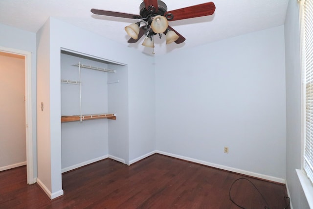 unfurnished bedroom featuring a closet, a ceiling fan, baseboards, and wood finished floors