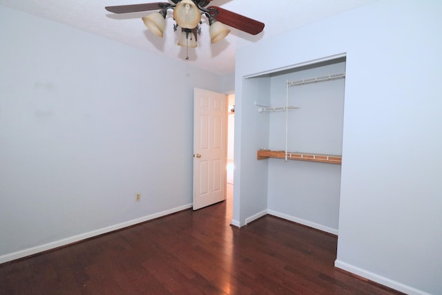 unfurnished bedroom with ceiling fan, a closet, and dark wood-type flooring