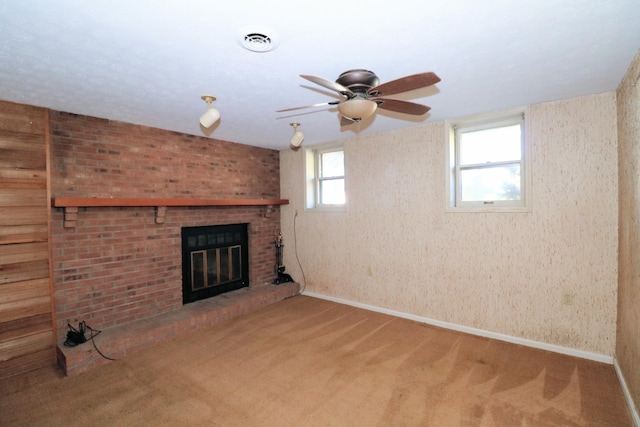 unfurnished living room with a fireplace, carpet, a ceiling fan, and visible vents