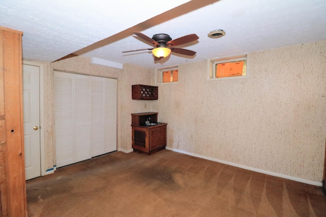 unfurnished bedroom with carpet floors, baseboards, ceiling fan, and a closet