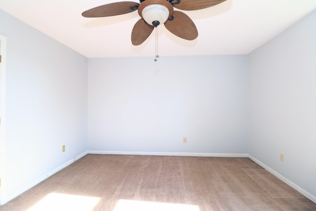 empty room featuring ceiling fan and light colored carpet