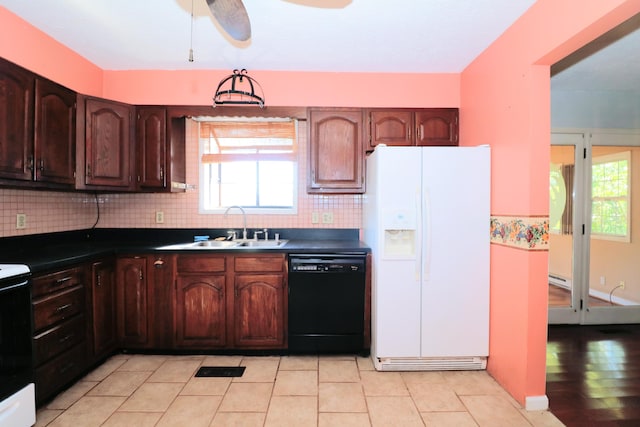 kitchen featuring a sink, backsplash, black appliances, and dark countertops