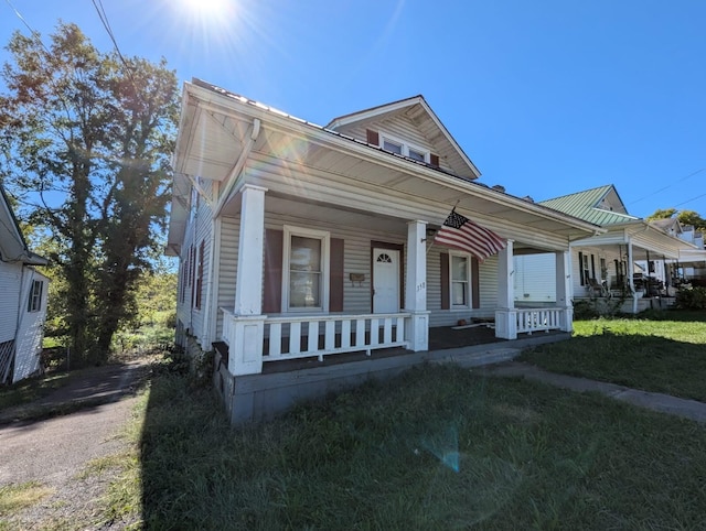 bungalow-style house with a porch and a front yard