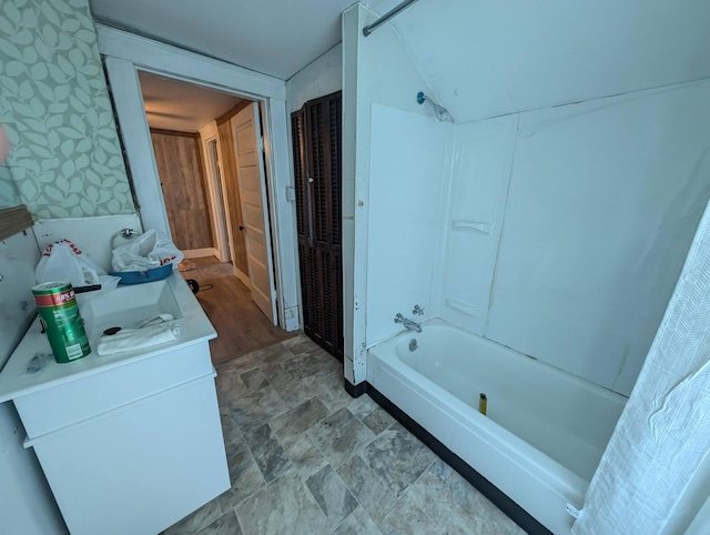 bathroom with vanity and shower / washtub combination