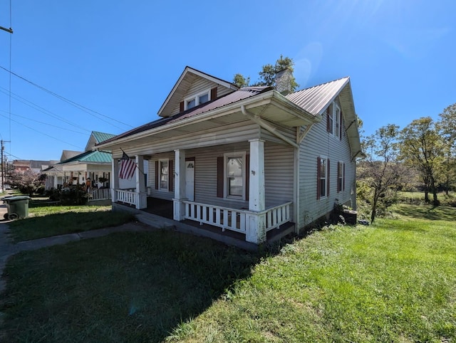 bungalow-style home featuring a porch and a front lawn