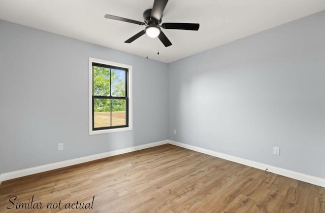 spare room with ceiling fan, baseboards, and wood finished floors