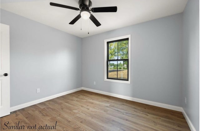 unfurnished room featuring a ceiling fan, baseboards, and wood finished floors