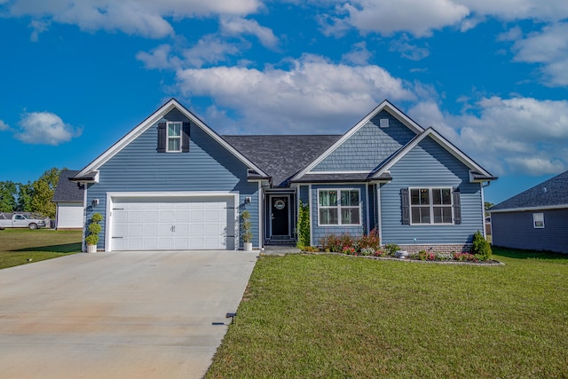 view of front of home with a garage and a front lawn