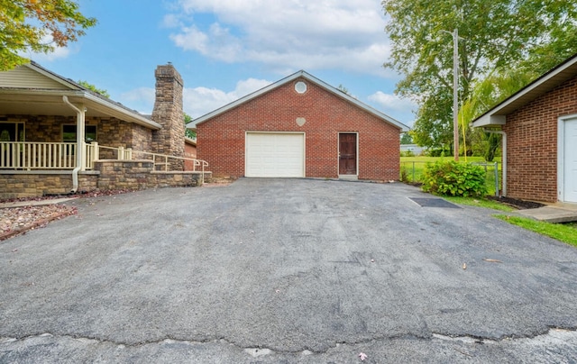 view of home's exterior with a garage and a porch