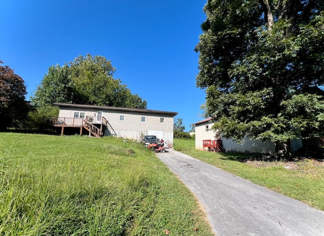 view of front of property with a front yard and a deck