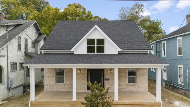 323 Conway St, Frankfort, KY 40601 - view of front of property featuring a porch, a shingled roof, brick siding, and board and batten siding