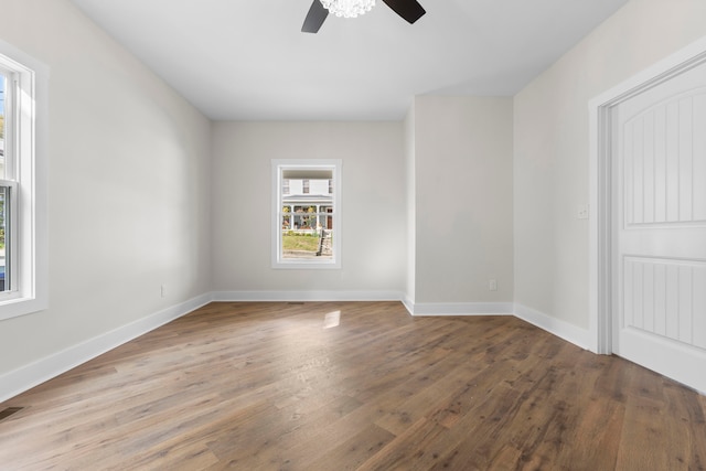 unfurnished room with ceiling fan and hardwood / wood-style floors