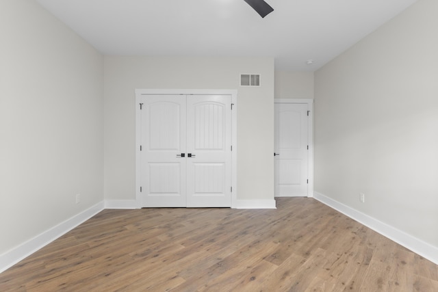 323 Conway St, Frankfort, KY 40601 - unfurnished bedroom with baseboards, wood finished floors, visible vents, and a closet