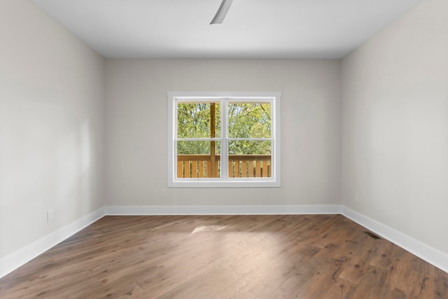 spare room featuring dark hardwood / wood-style floors