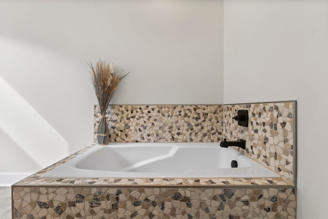 bathroom with a relaxing tiled tub