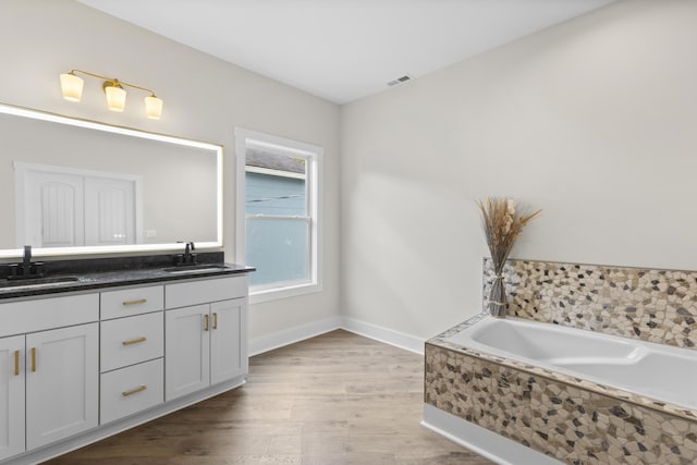 323 Conway St, Frankfort, KY 40601 - bathroom with double vanity, wood finished floors, visible vents, and a sink