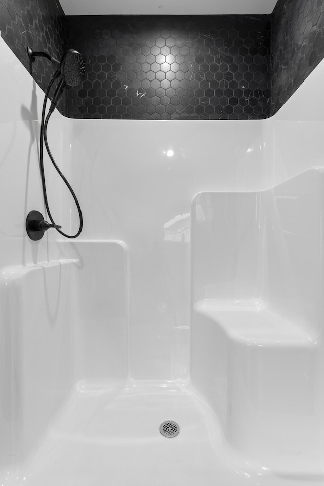 interior details featuring a shower