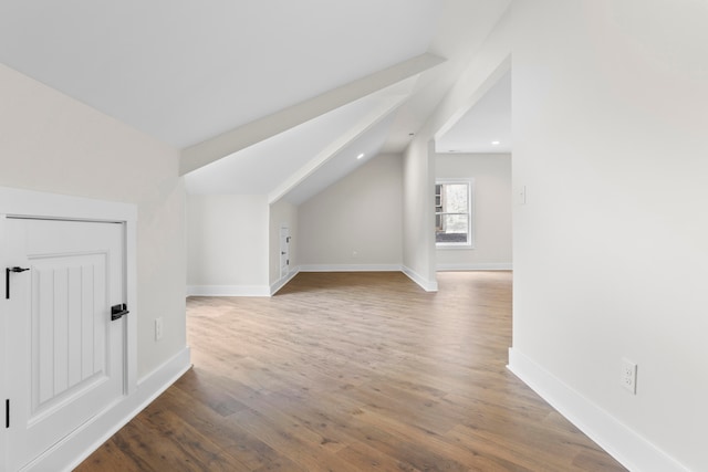 bonus room with wood-type flooring and lofted ceiling