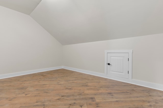 bonus room featuring lofted ceiling and light hardwood / wood-style flooring