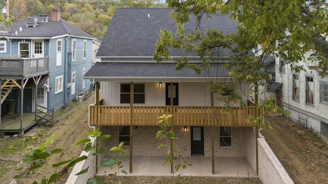 323 Conway St, Frankfort, KY 40601 - rear view of house featuring a deck, roof with shingles, brick siding, and a patio