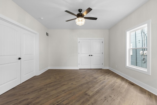 323 Conway St, Frankfort, KY 40601 - unfurnished bedroom featuring wood finished floors, visible vents, a ceiling fan, and baseboards