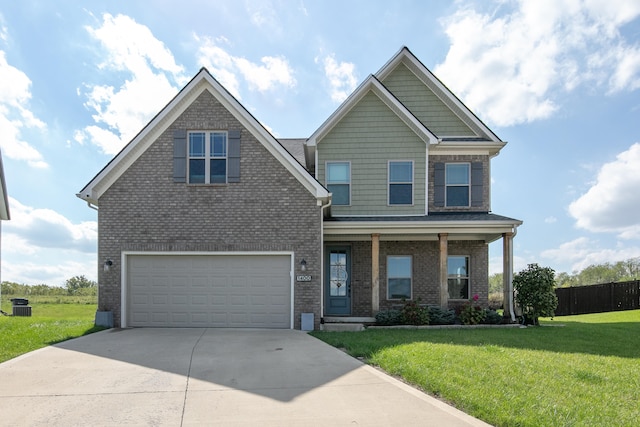 craftsman house with cooling unit, covered porch, a front yard, and a garage