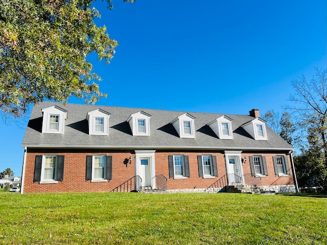 cape cod home with a front yard